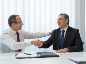 Article LLC vs Holding néerlandaise - Deux hommes d'affaires qui se serrent la main